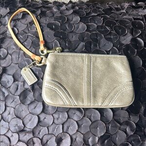 Elegant Gold Clutch Wristlet with Seam and Charm
